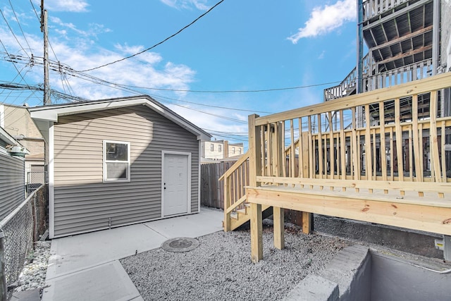 wooden deck featuring a patio and fence