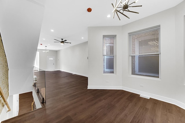 unfurnished living room featuring dark wood-style floors, visible vents, baseboards, and recessed lighting