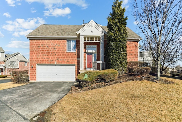 view of front facade featuring a garage, aphalt driveway, a front yard, and brick siding