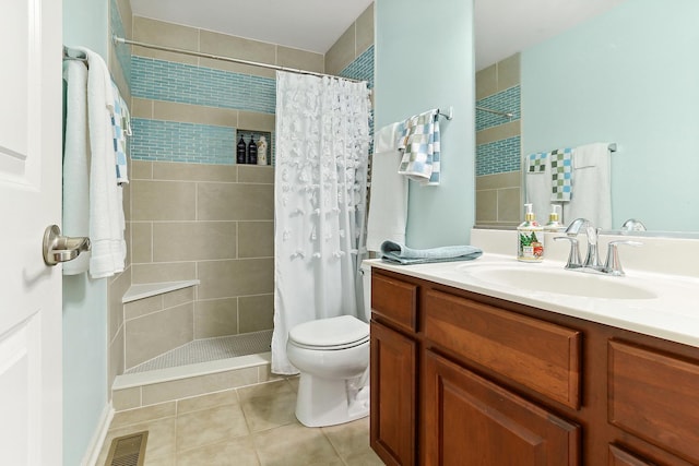 bathroom with toilet, tiled shower, tile patterned flooring, and visible vents