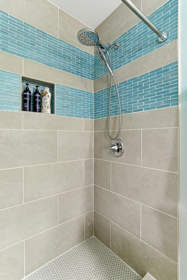 bathroom with a tile shower