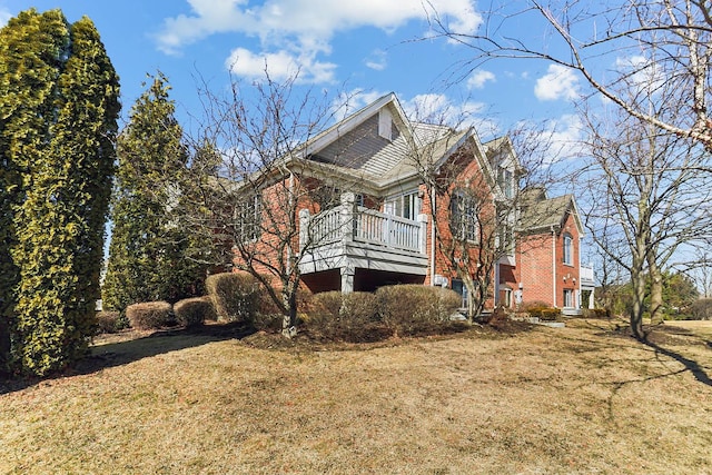 view of property exterior with a yard and brick siding