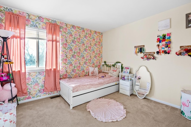 bedroom with light carpet and baseboards