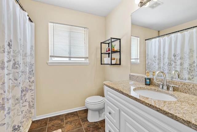 bathroom featuring visible vents, toilet, tile patterned flooring, baseboards, and vanity