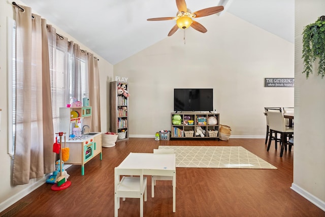 rec room featuring ceiling fan, high vaulted ceiling, baseboards, and wood finished floors