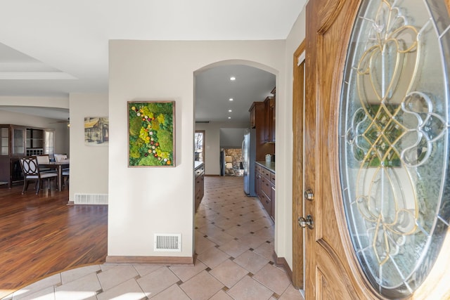 foyer with light tile patterned floors, recessed lighting, visible vents, and baseboards