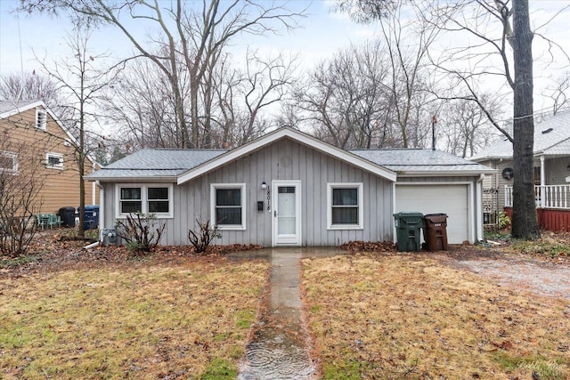 single story home with a shingled roof and board and batten siding