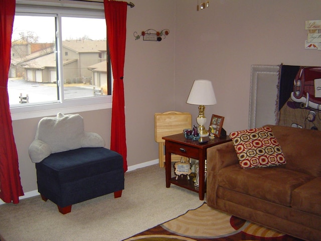 living room featuring carpet flooring and baseboards