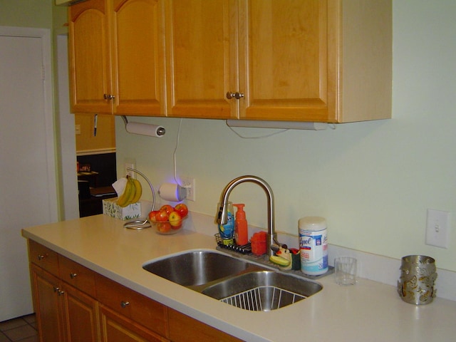 kitchen with brown cabinets, light countertops, and a sink