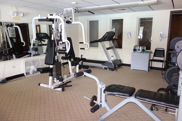 workout area with a drop ceiling and carpet flooring