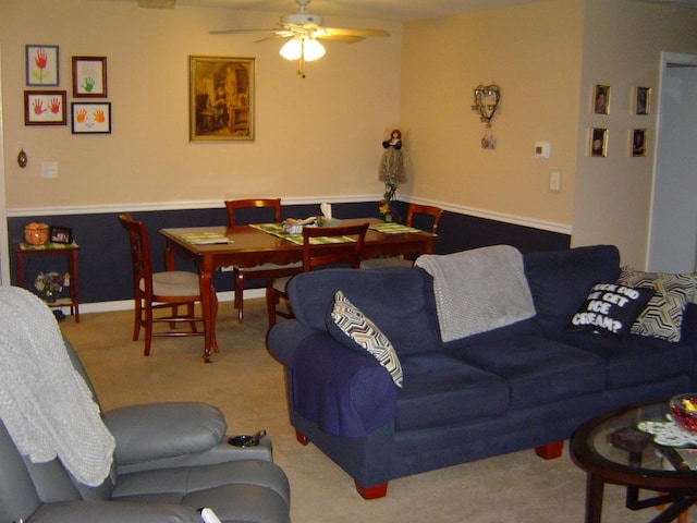 carpeted living room with baseboards and ceiling fan