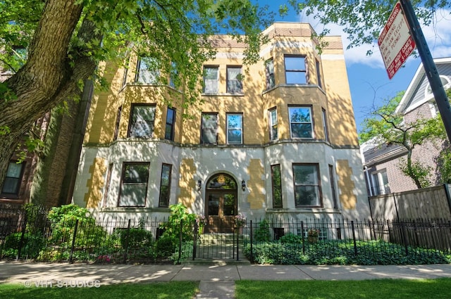 view of front of home with a fenced front yard and a gate