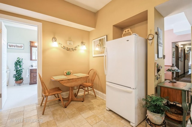 kitchen with freestanding refrigerator