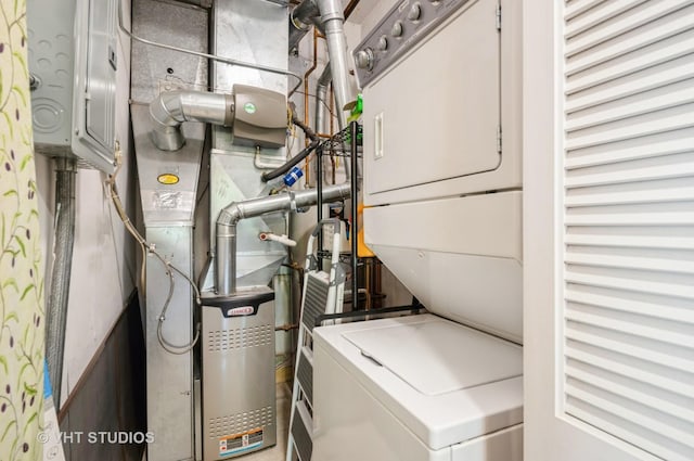 clothes washing area featuring laundry area and stacked washer / dryer