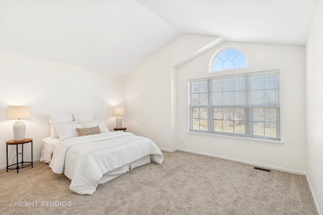 carpeted bedroom featuring vaulted ceiling, multiple windows, visible vents, and baseboards