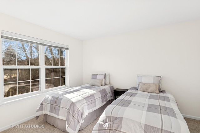 bedroom featuring carpet and baseboards