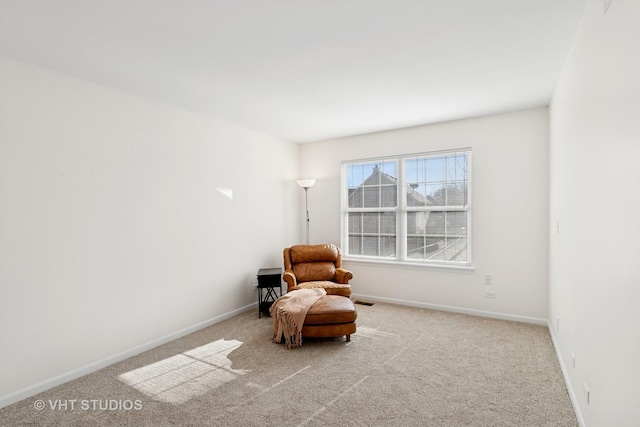 living area with carpet flooring and baseboards