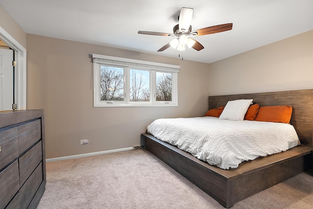 carpeted bedroom featuring ceiling fan and baseboards