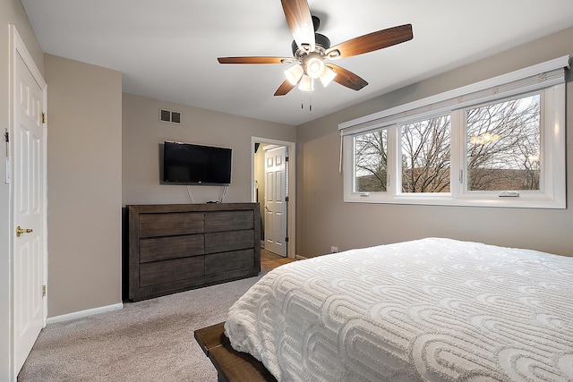 bedroom featuring ceiling fan, carpet, visible vents, and baseboards