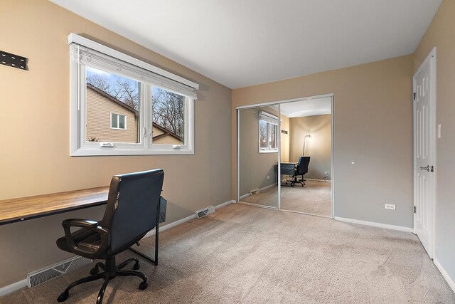 home office with carpet, visible vents, and baseboards