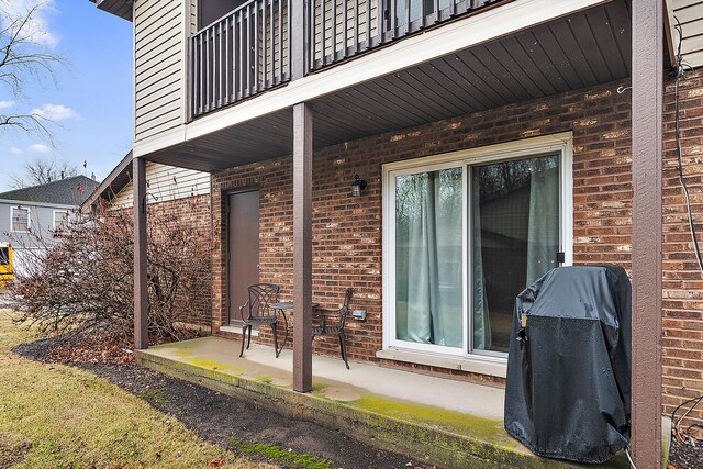 view of patio / terrace featuring area for grilling and a balcony