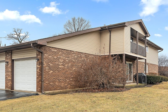 view of side of home with a yard and brick siding