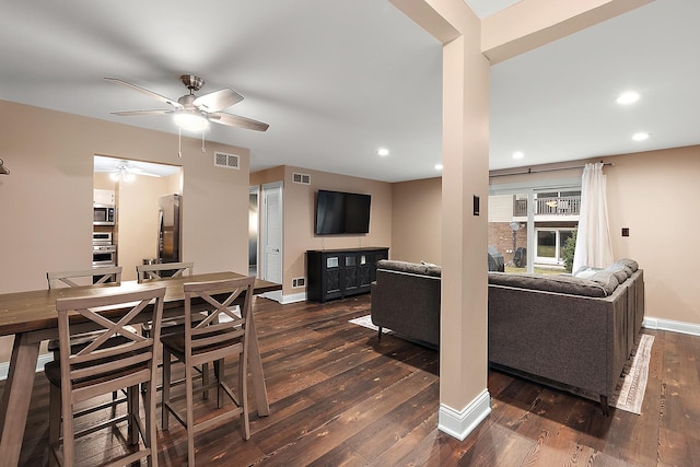 living room with recessed lighting, wood-type flooring, visible vents, and baseboards