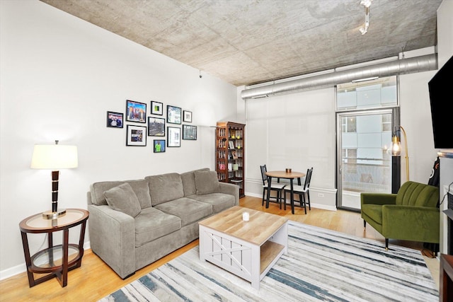 living room with wood finished floors and baseboards