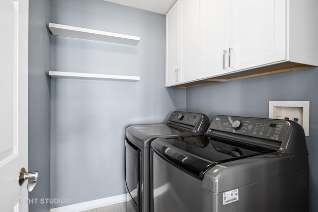 washroom with washer and dryer and cabinet space