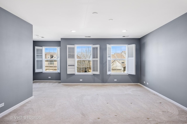 spare room with a wealth of natural light, baseboards, and carpet floors