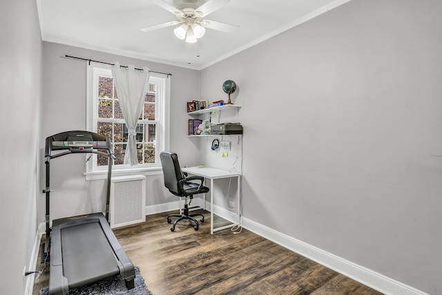 office space featuring ornamental molding, baseboards, and wood finished floors