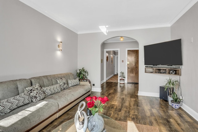 living area featuring baseboards, arched walkways, wood finished floors, and ornamental molding