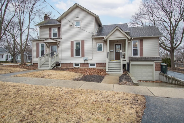 view of front of home with an attached garage, a chimney, and roof with shingles