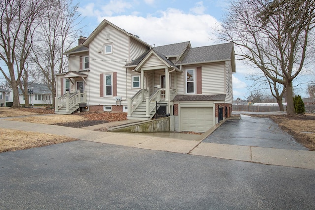 view of front of property featuring a garage, aphalt driveway, a chimney, and a shingled roof