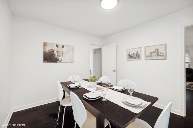 dining space with baseboards and dark wood-style flooring