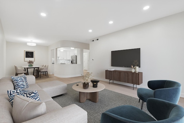 living area featuring recessed lighting, visible vents, and baseboards