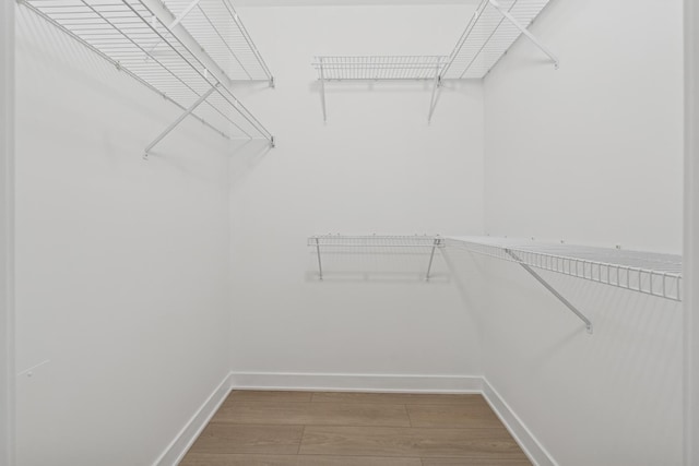 spacious closet with wood finished floors