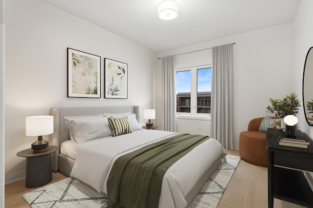 bedroom featuring baseboards and light wood-type flooring