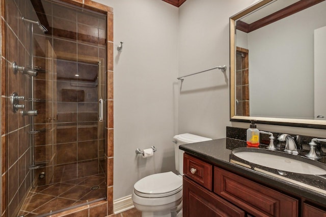 bathroom featuring vanity, a shower stall, and toilet