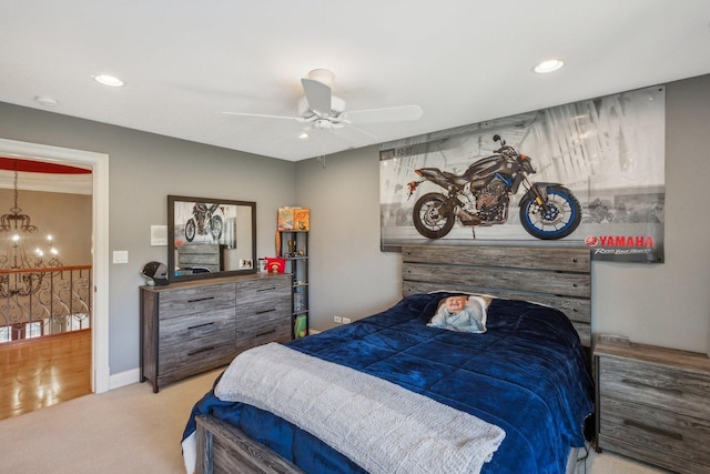 bedroom featuring ceiling fan with notable chandelier, carpet floors, baseboards, and recessed lighting