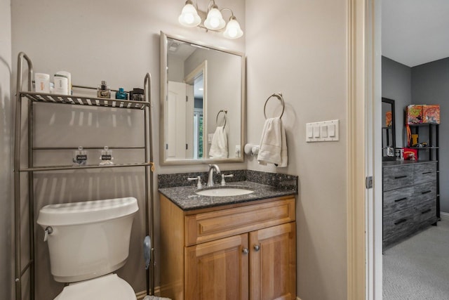 bathroom with toilet and vanity