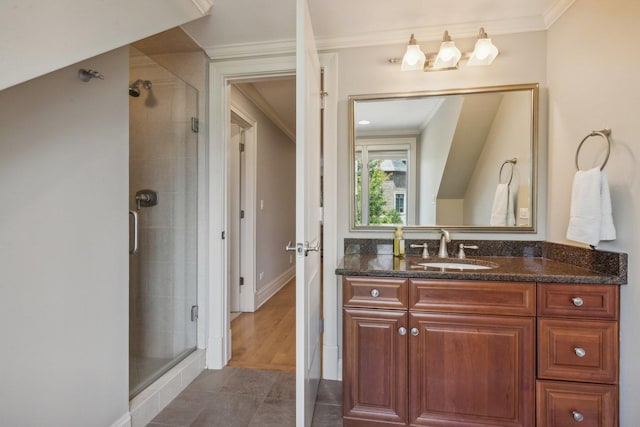 bathroom with baseboards, ornamental molding, tile patterned flooring, vanity, and a shower stall