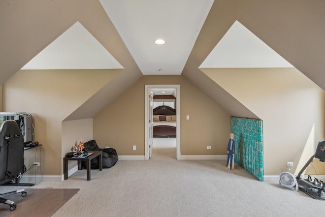 workout room featuring vaulted ceiling, carpet, and baseboards