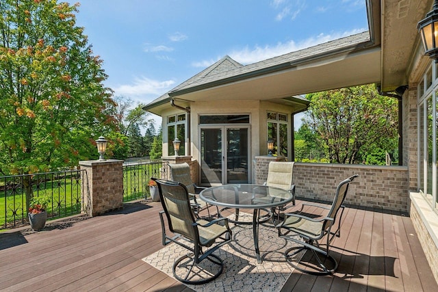 wooden terrace with outdoor dining space