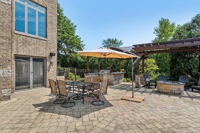 view of patio with outdoor dining space, a fire pit, a pergola, and area for grilling