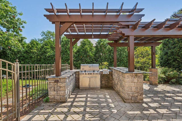 view of patio / terrace with an outdoor kitchen, a grill, and a pergola