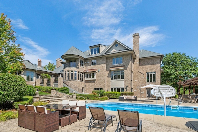 outdoor pool with a patio area, stairs, an outdoor hangout area, and a pergola