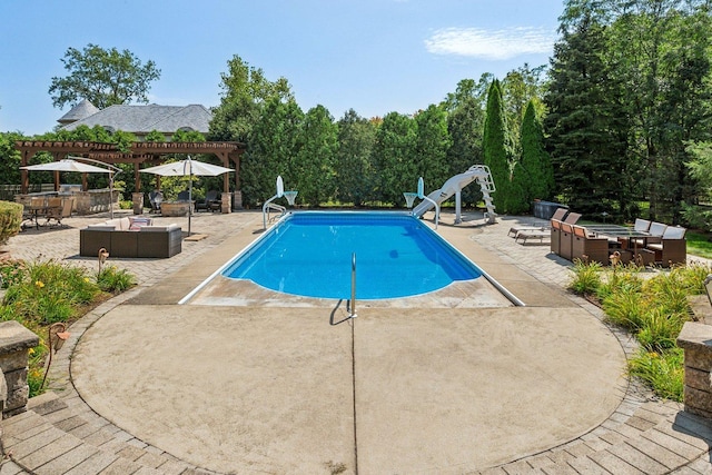 outdoor pool featuring a pergola, outdoor lounge area, a water slide, and a patio