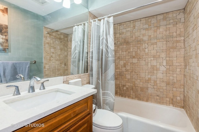 full bath featuring visible vents, toilet, vanity, and shower / bath combo