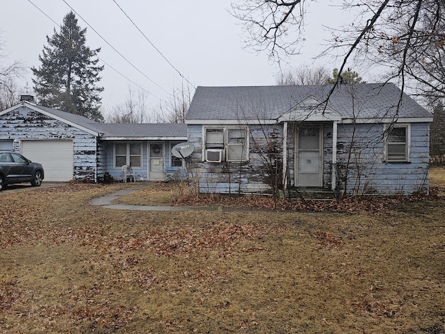 view of front of property with a garage and cooling unit